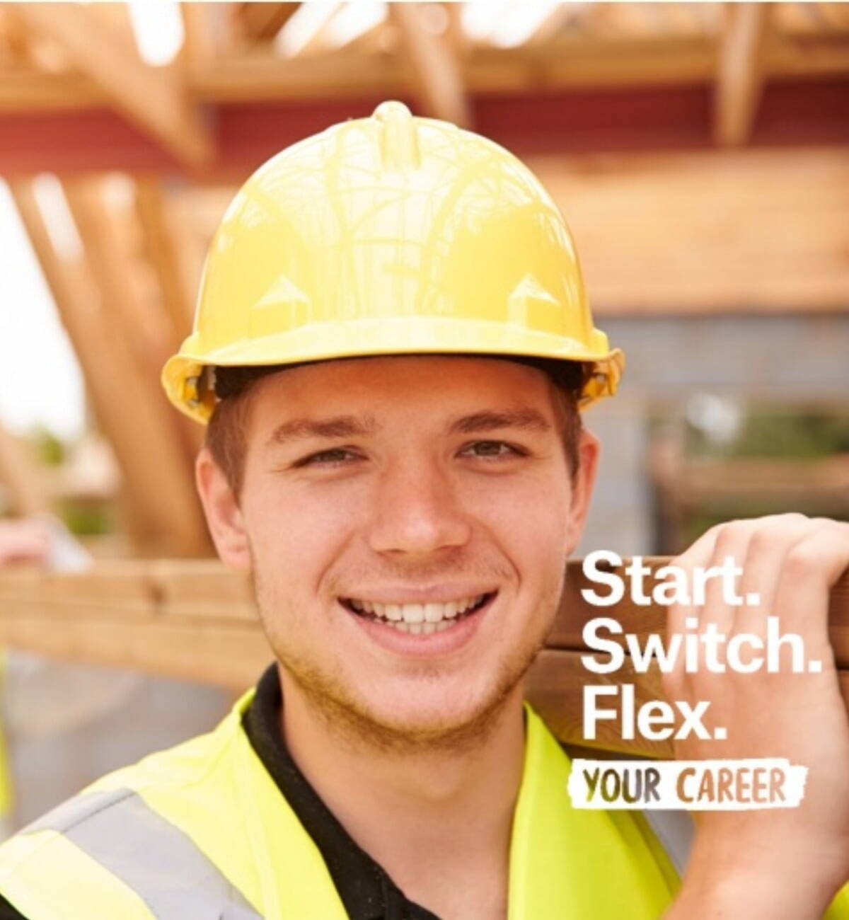 Man in hard hat carrying wood