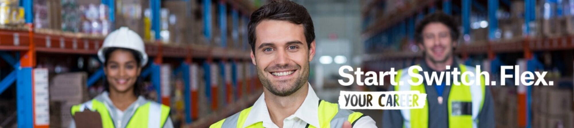 Man in warehouse smiling at camera