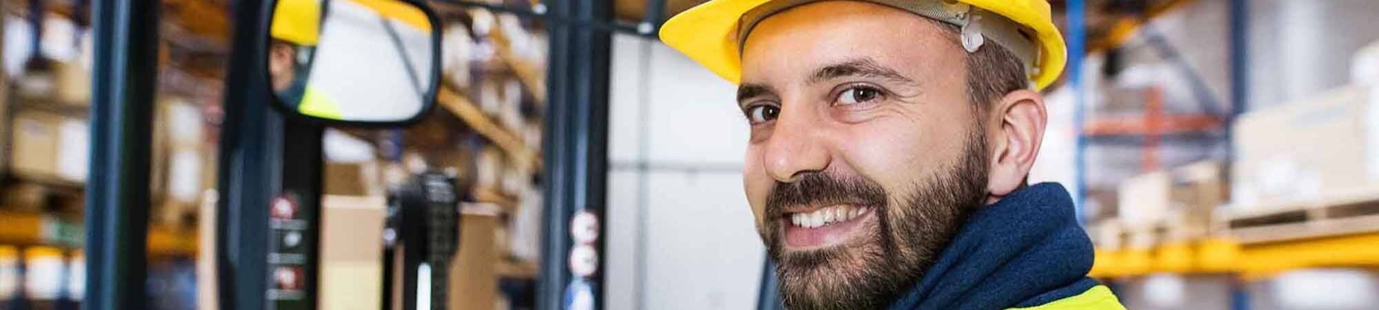 Trojan worker smiling at camera wearing hard hat