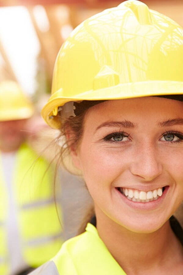 Trojan worker in hard hat smiling at camera