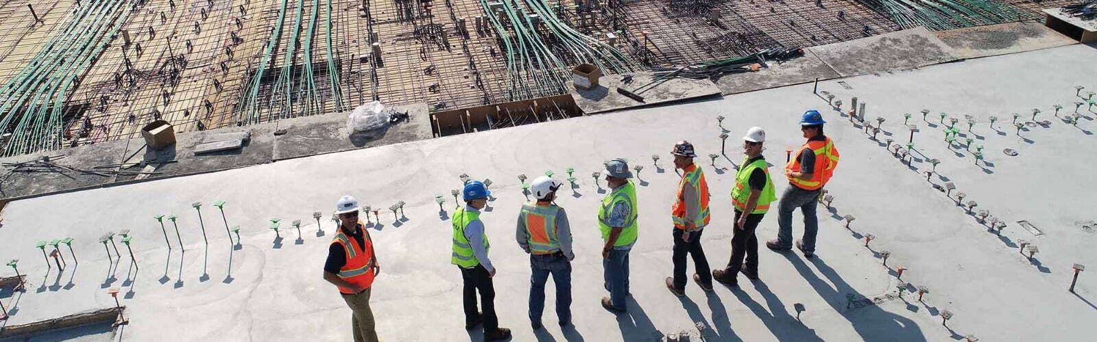 newly recruited construction workers lined up on building site