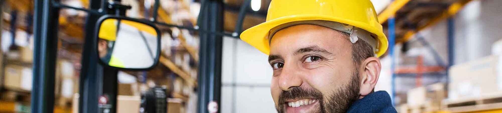 man on forklift smiling at camera