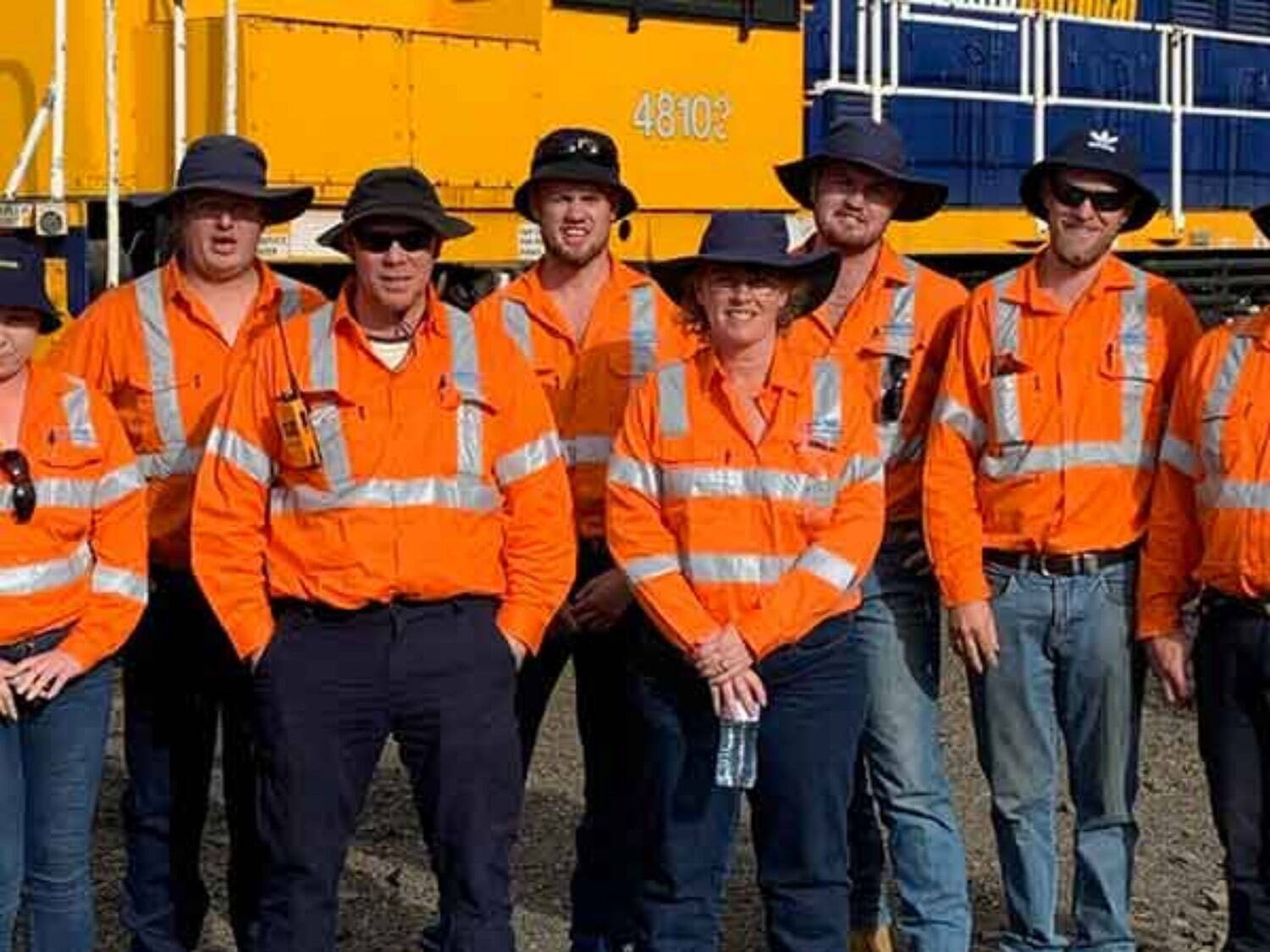 Training school taking photo in front of locomotive