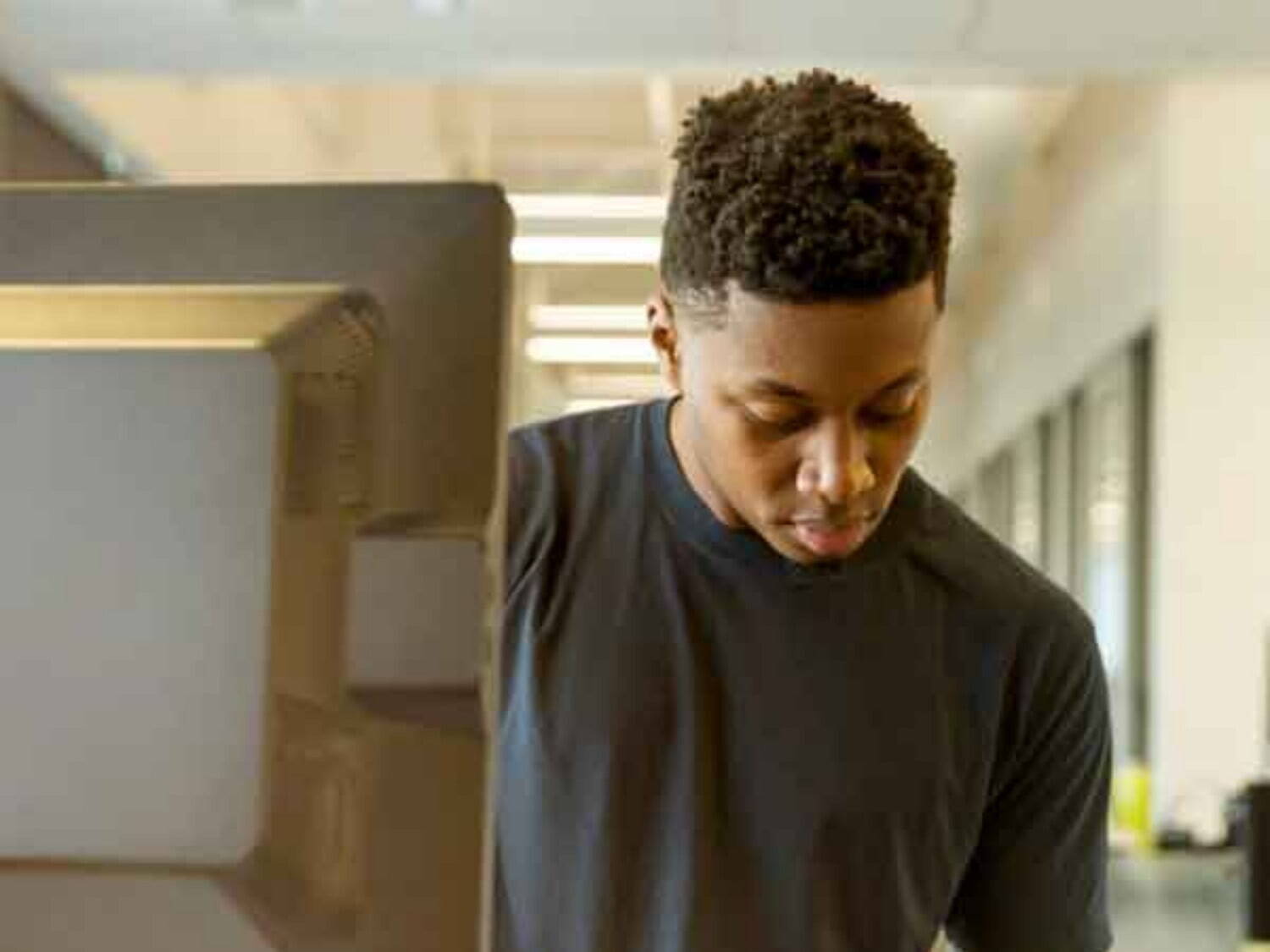 young man writing on a notepad submitting manual timesheet